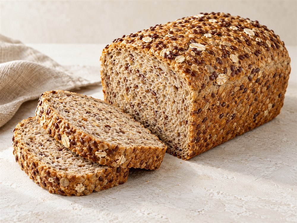 Illustrative photo of a multigrain loaf with flaxseeds and sliced crumb